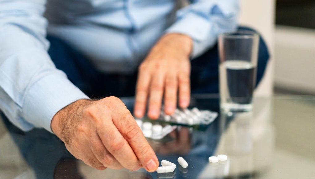 Hands with pills. Senior man hands with medical pill and glass of water. Mature old senior grandfather taking medication cure pills vitamin. Age prescription medicine healthcare therapy concept