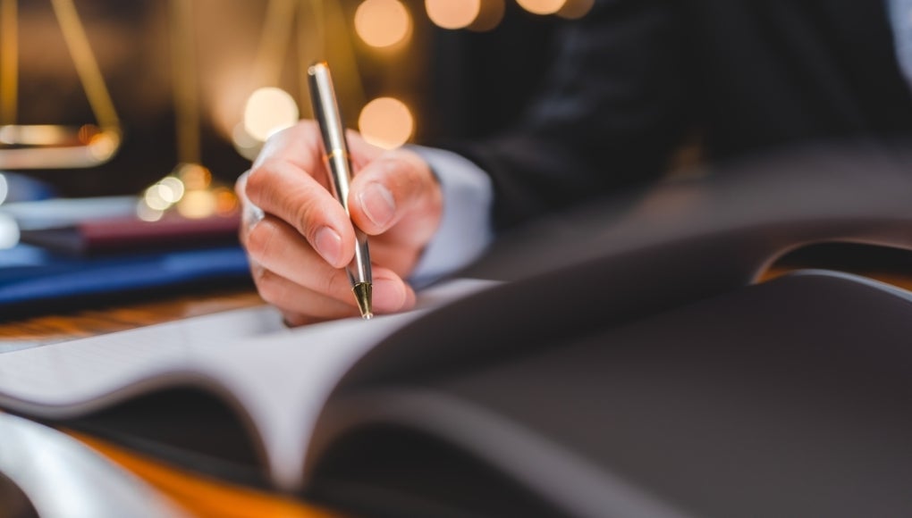 lawyer signing contract with client 