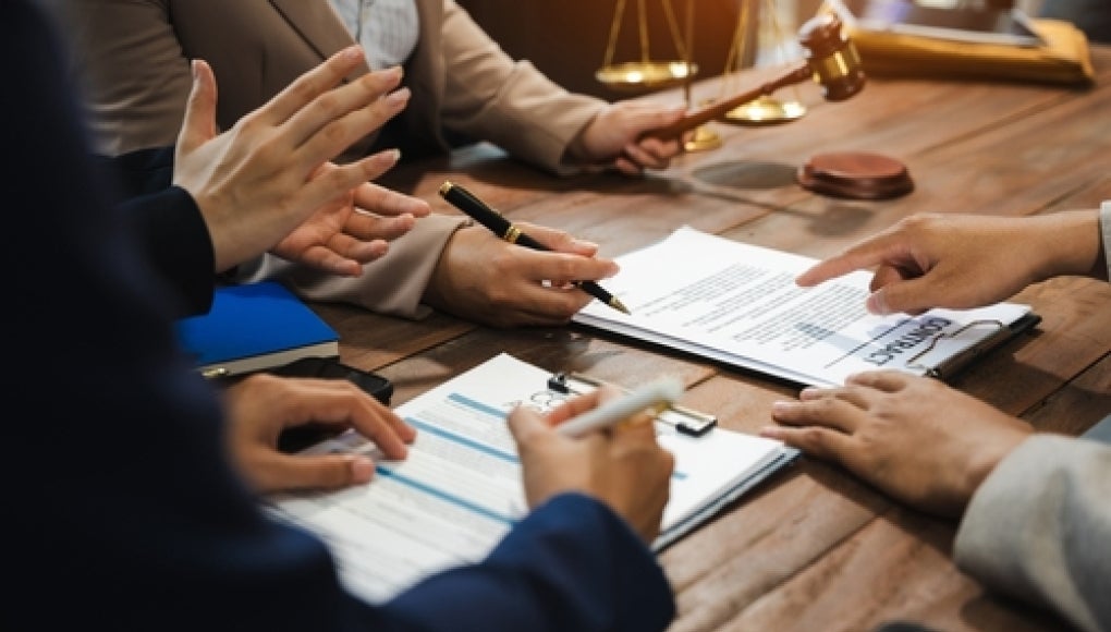 group of employees discussing contract agreement together