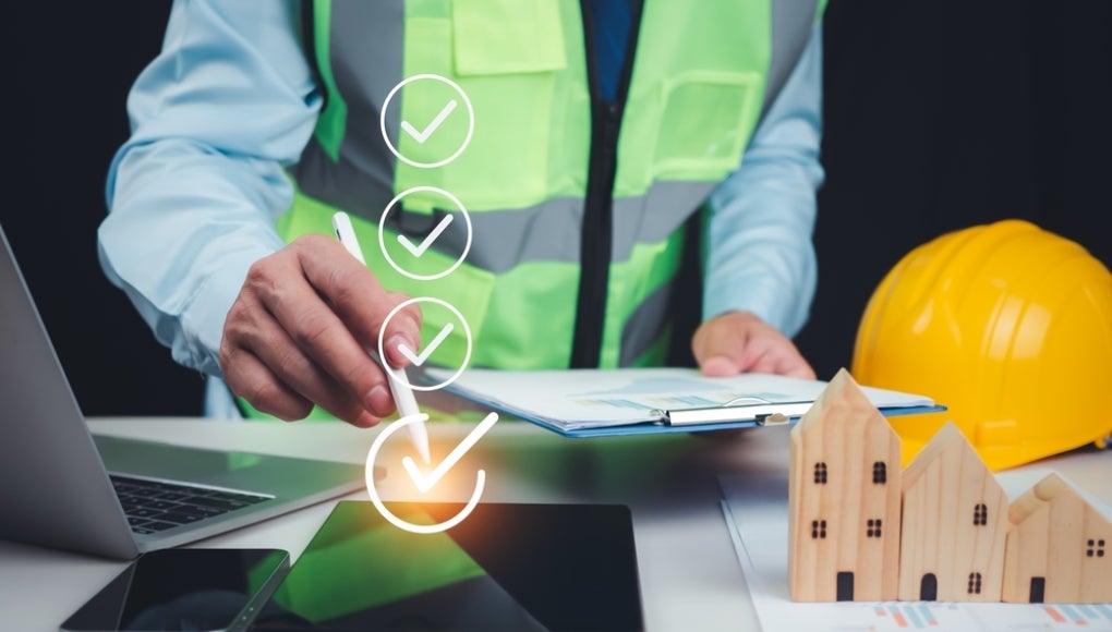 Validation of construction project inspection and approved building permits, with an architect or engineer reviewing documents and authorizing a residential building project.