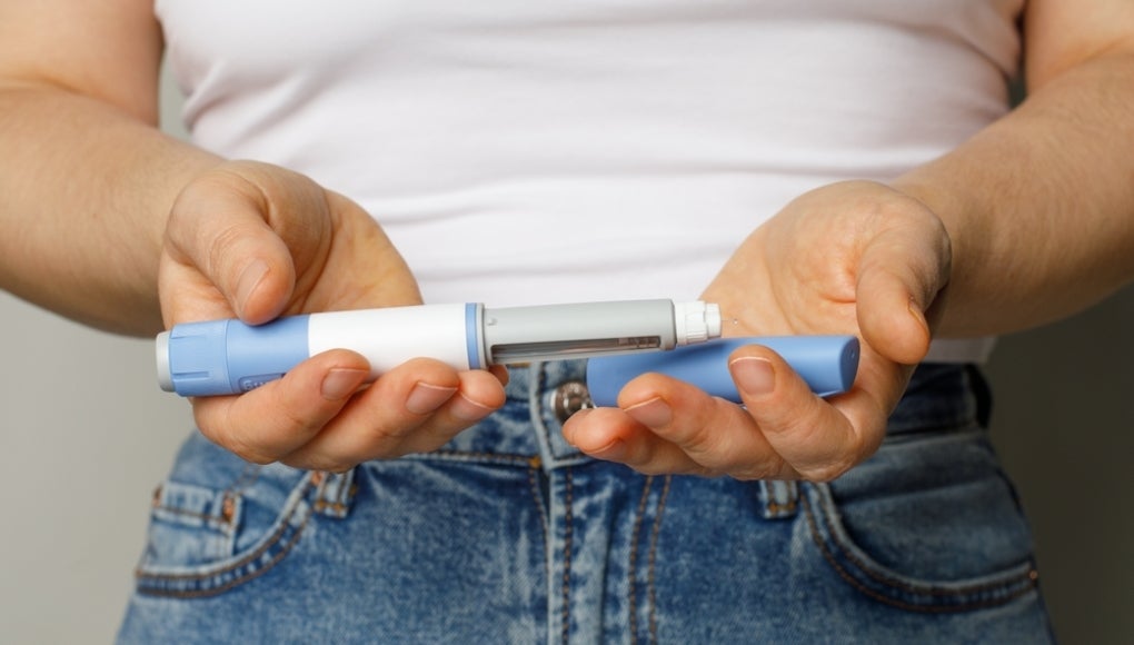 person holding two vaccines