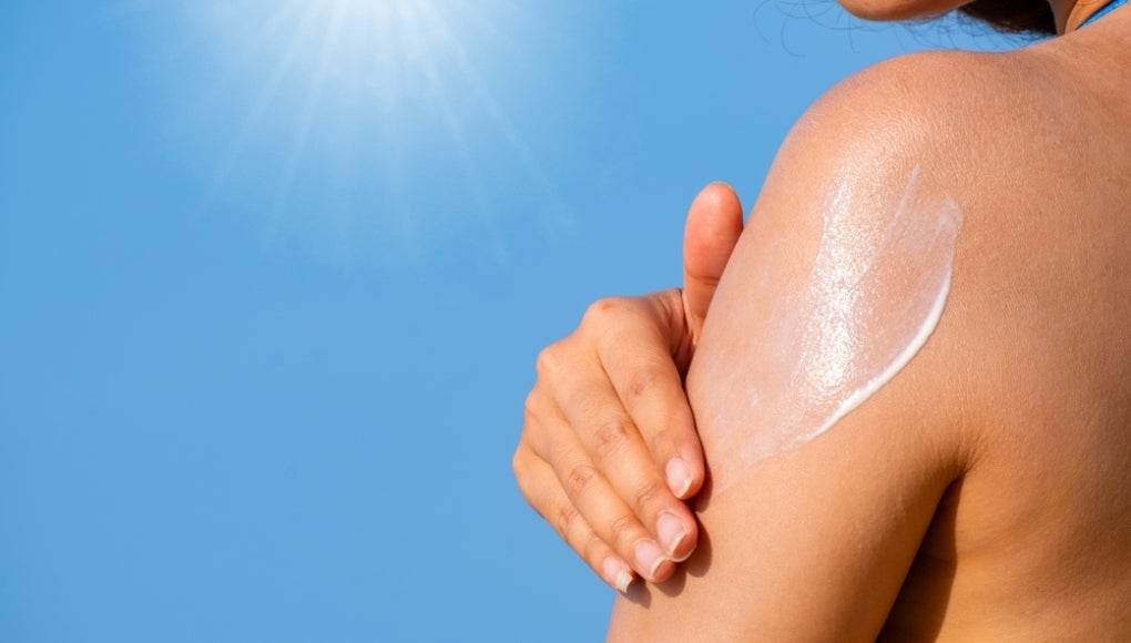 Woman applying sunscreen