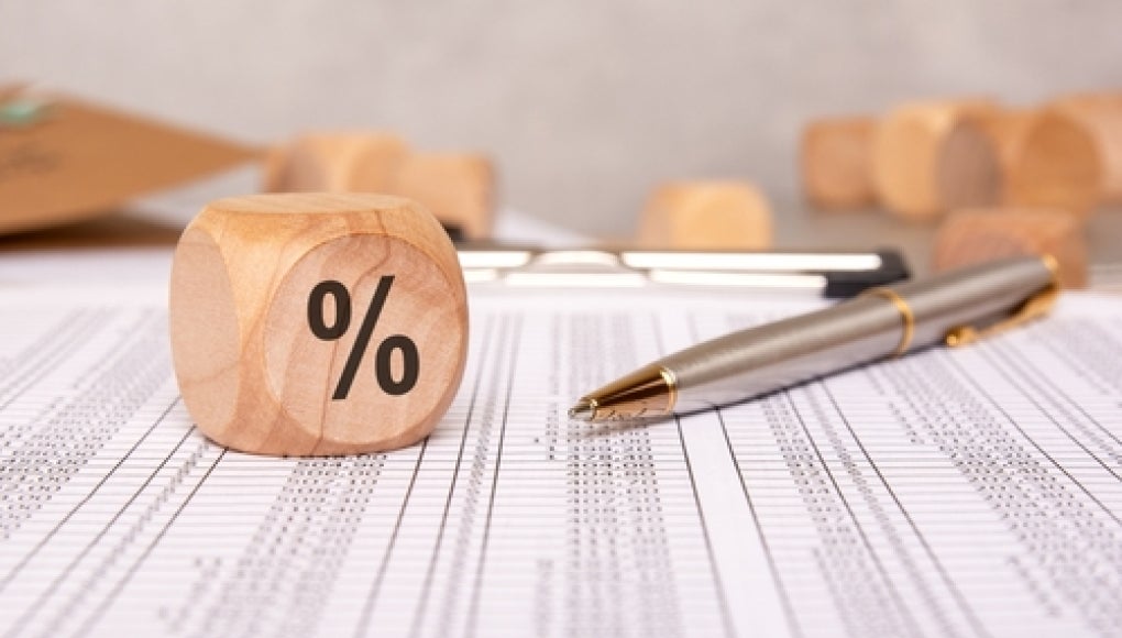 percentage block and various paperwork with numerical caluclations 