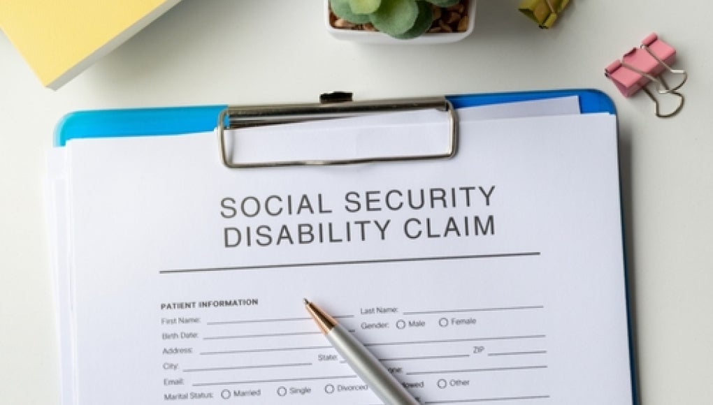 clip board with social security disability claim papers on it. 