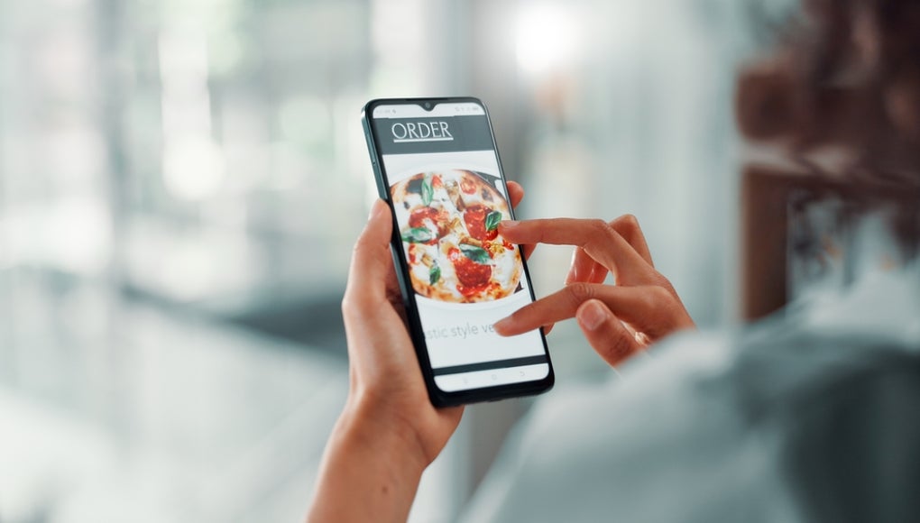 Business, hands and phone screen for food delivery order with menu option, online shopping and lunch break. Woman, space and scroll with smartphone for pizza app and brunch takeout choice in office