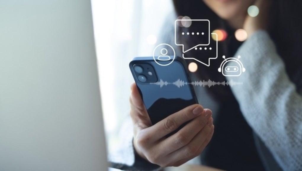 person holding phone with ai chatbot floating over it 