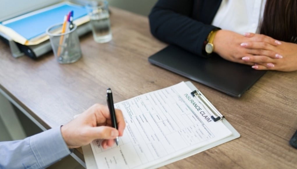 two people reviewing insurance form 