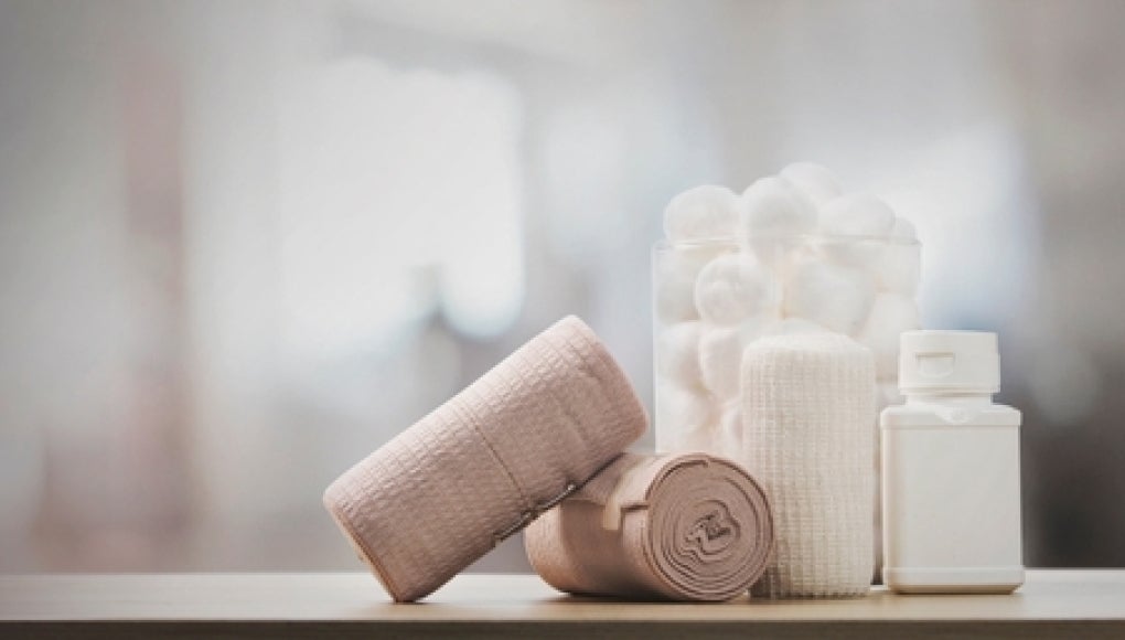 pile of various bandages and gauze in a nursing home room.