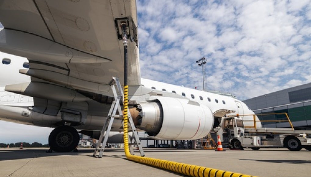 photo of airplaine refueling at airport 