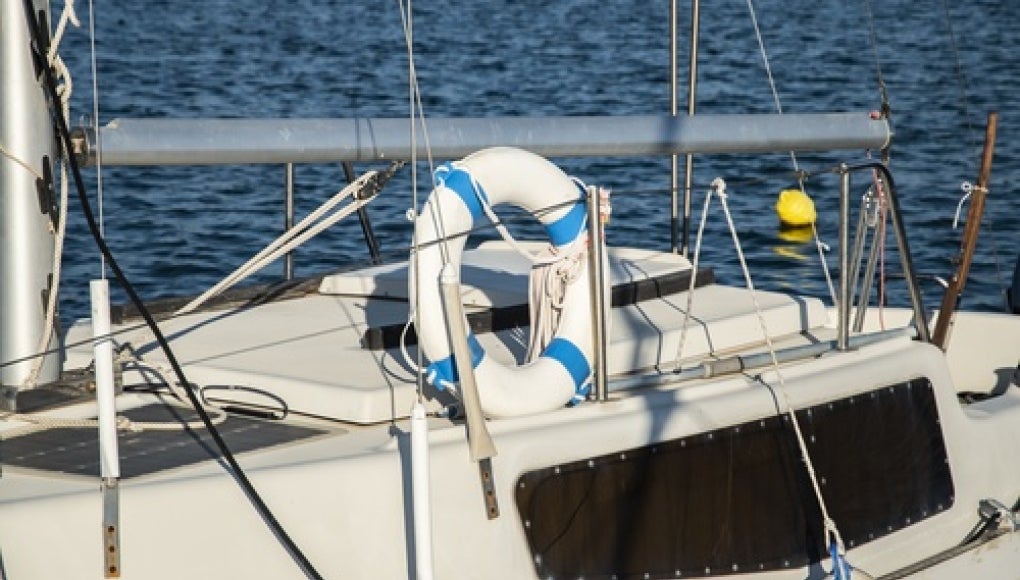 white yacht with life raft on it 