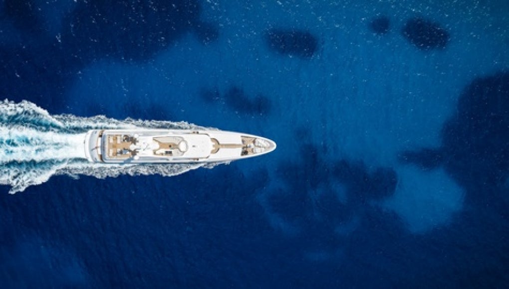 boat making wake in open water