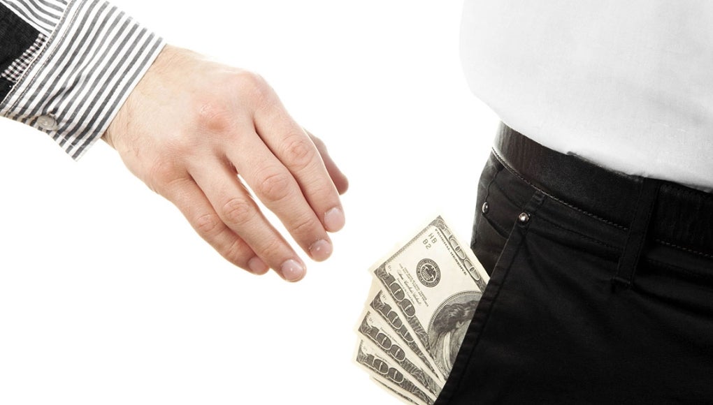 What if You’re a Victim of Wage Theft and You Don’t Even Know It? - A hand reaching into a person's pocket to get money