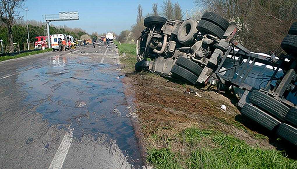 Crash truck tipped over on side of road