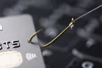 credit card on a fishing hook indicating a phishing or financial c