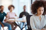person at work being made to feel excluded by coworkers