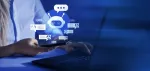 person sitting at laptop with AI chat bot floating above it