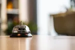bell on reception desk at hotel 