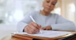 woman sitting with documents and forms for life insurance