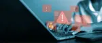 person at laptop with red warning signs