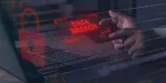 data breach image of a red warning sign that appears above a keyboard