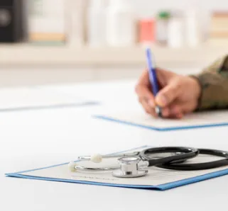 veteran filling out forms on desk