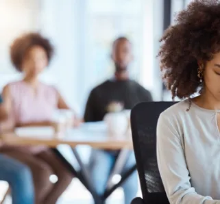 person at work being made to feel excluded by coworkers