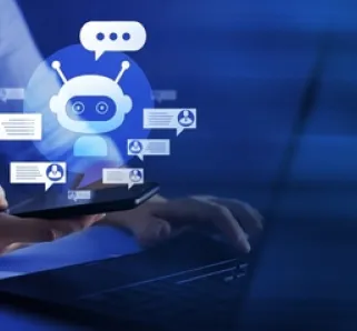 person sitting at laptop with AI chat bot floating above it 