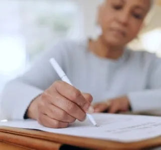 woman sitting with documents and forms for life insurance