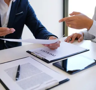 two people in button down suits reviewing insurance policies