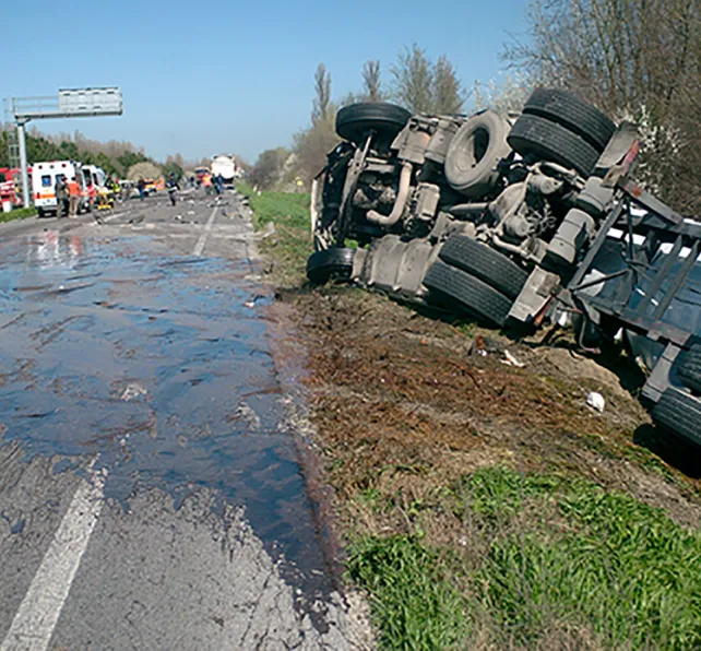 Crash truck tipped over on side of road