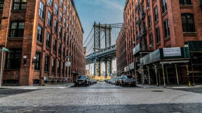 View of a Brooklyn street leading to the bridge, embodying the neighborhood's spirit for local personal injury lawyers.
