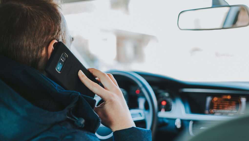 a man using his phone while driving
