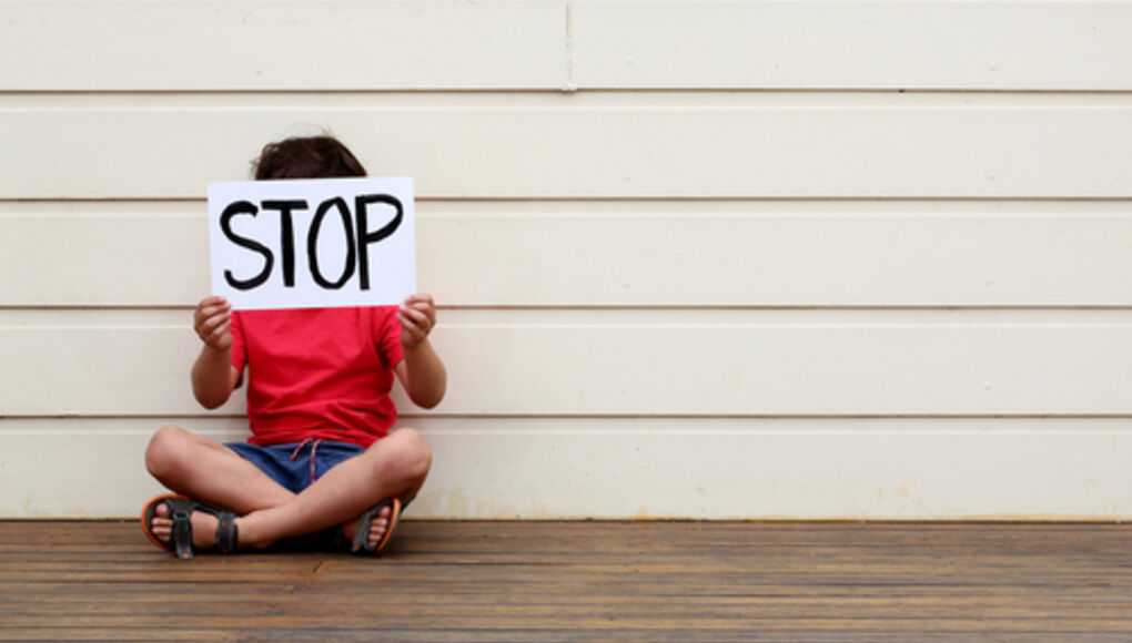 Florida Teen Combats Bullying With His Own Foundation - Kid Holding a Stop Bullying Sign