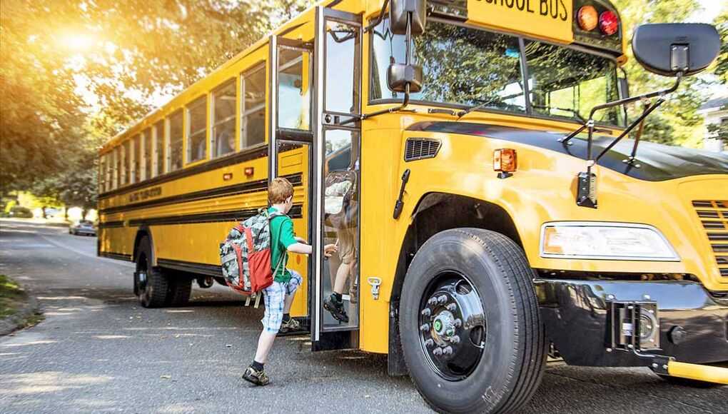 FL School District Tackles Bullying on the Bus - child riding a school bus