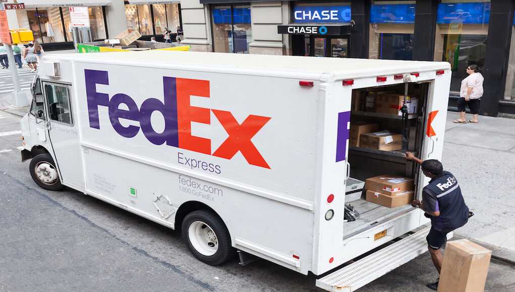 Fedex driver taking packages from van