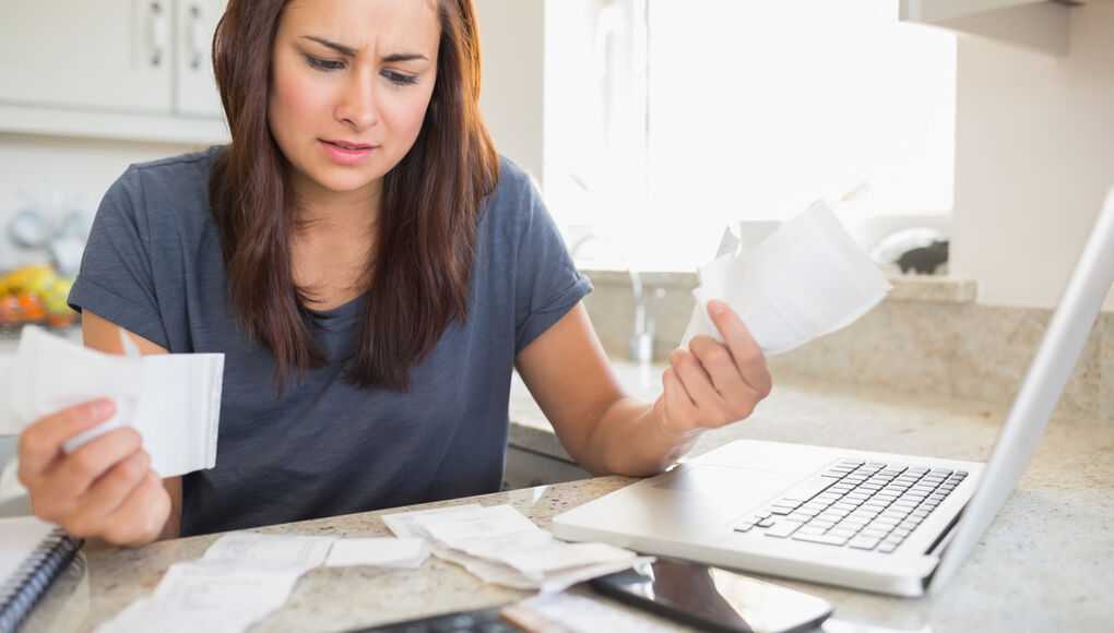 stressed woman looking at life insurance policy