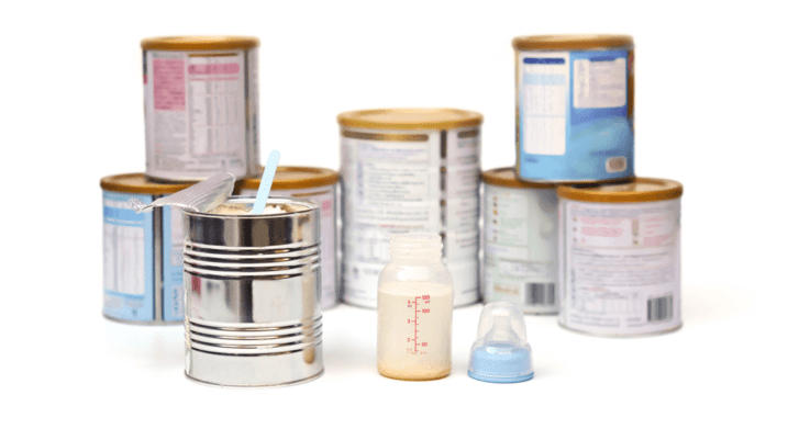 powder milk in a can with spoon with different brands of powder milk background