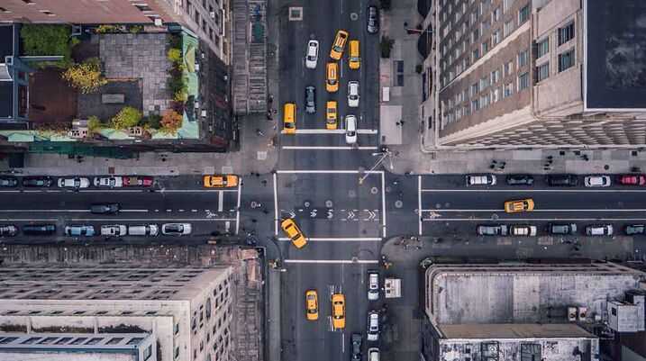 What NYC’s Plan for Improving Pedestrian Safety Means for You - A bustling city with numerous cars on the streets.