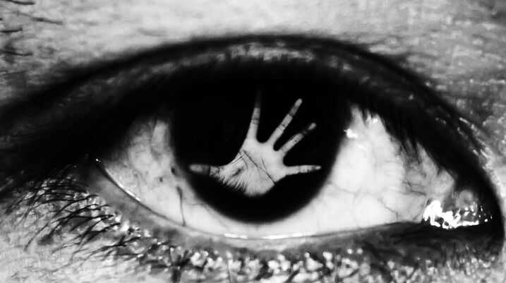 eye with hand in pupil