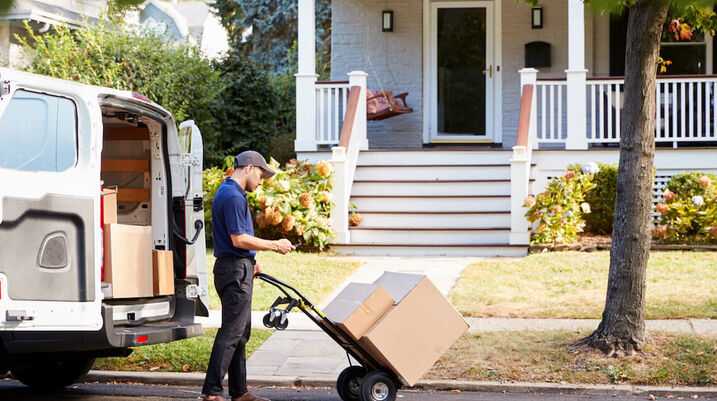 courier delivery driver on curb with packages