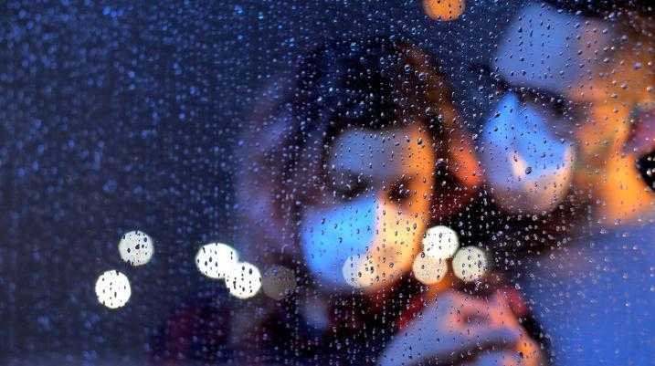 Couple with mask on in rain