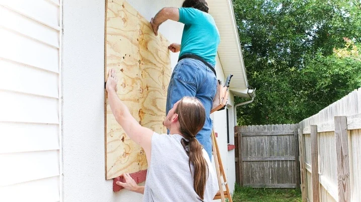 Men boarding up windows