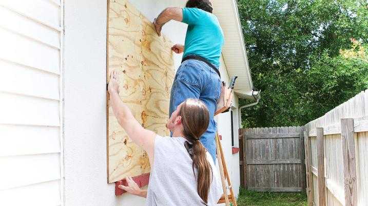 Men boarding up windows