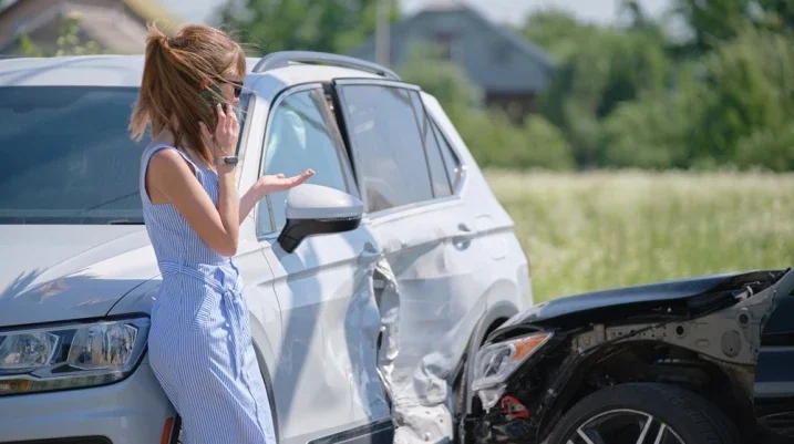 Woman on the phone after a car accident