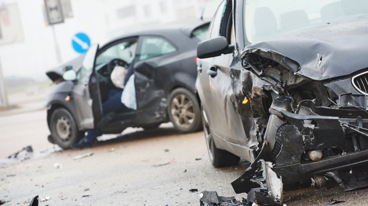 Two black cars with severe damage after an accident