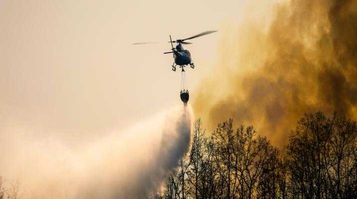 Helicopter watering fiery forest