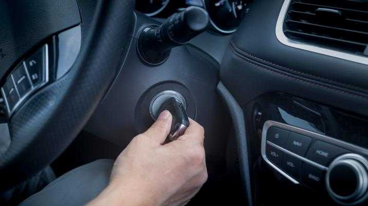 Someone turning a key to start a car