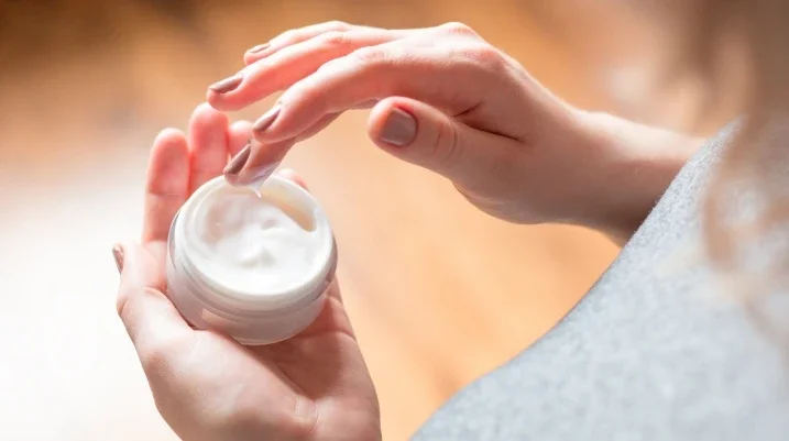 Woman holding facial cream