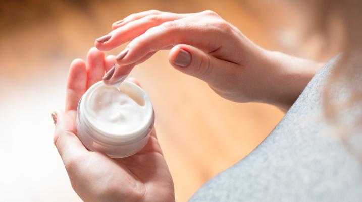 Woman holding facial cream