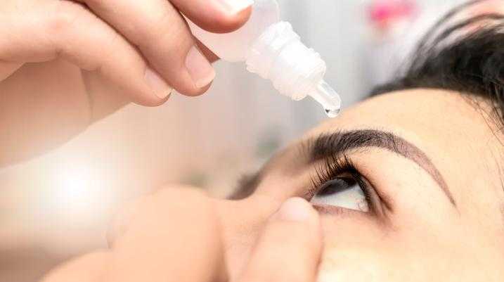 Woman using eyedrops